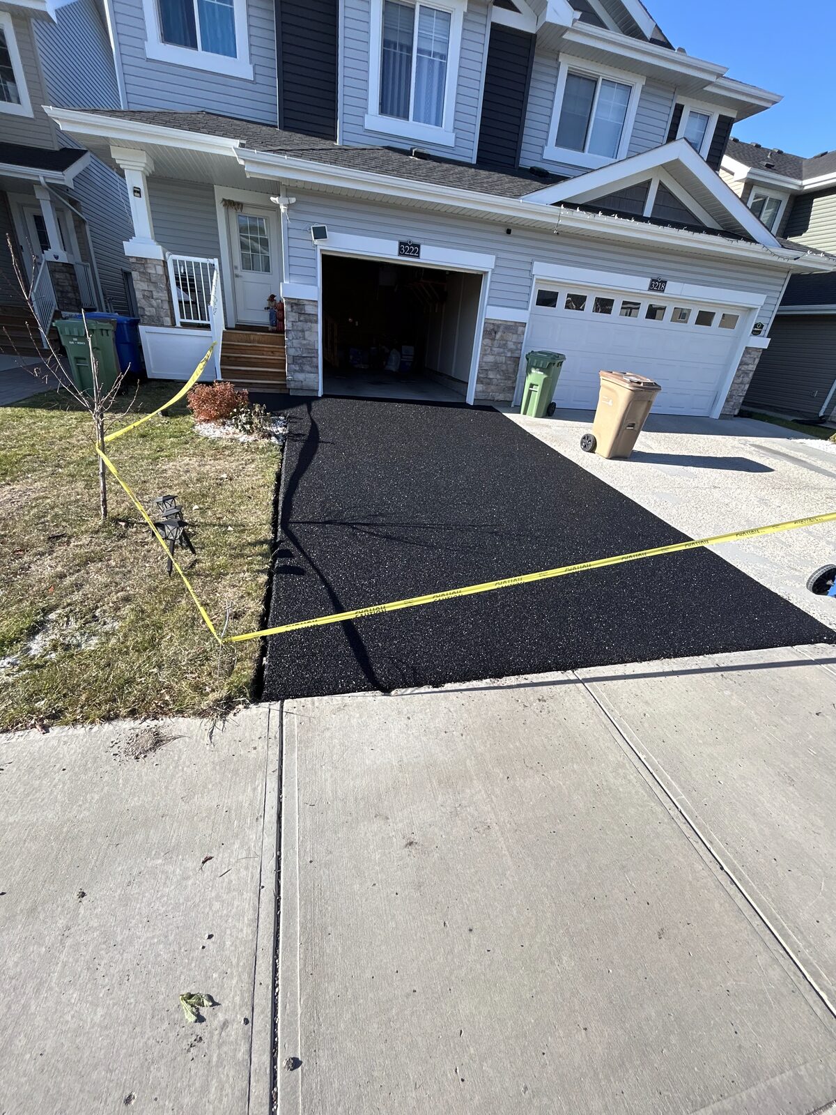 Black rubber driveway resurfacing at a Saskatchewan home
