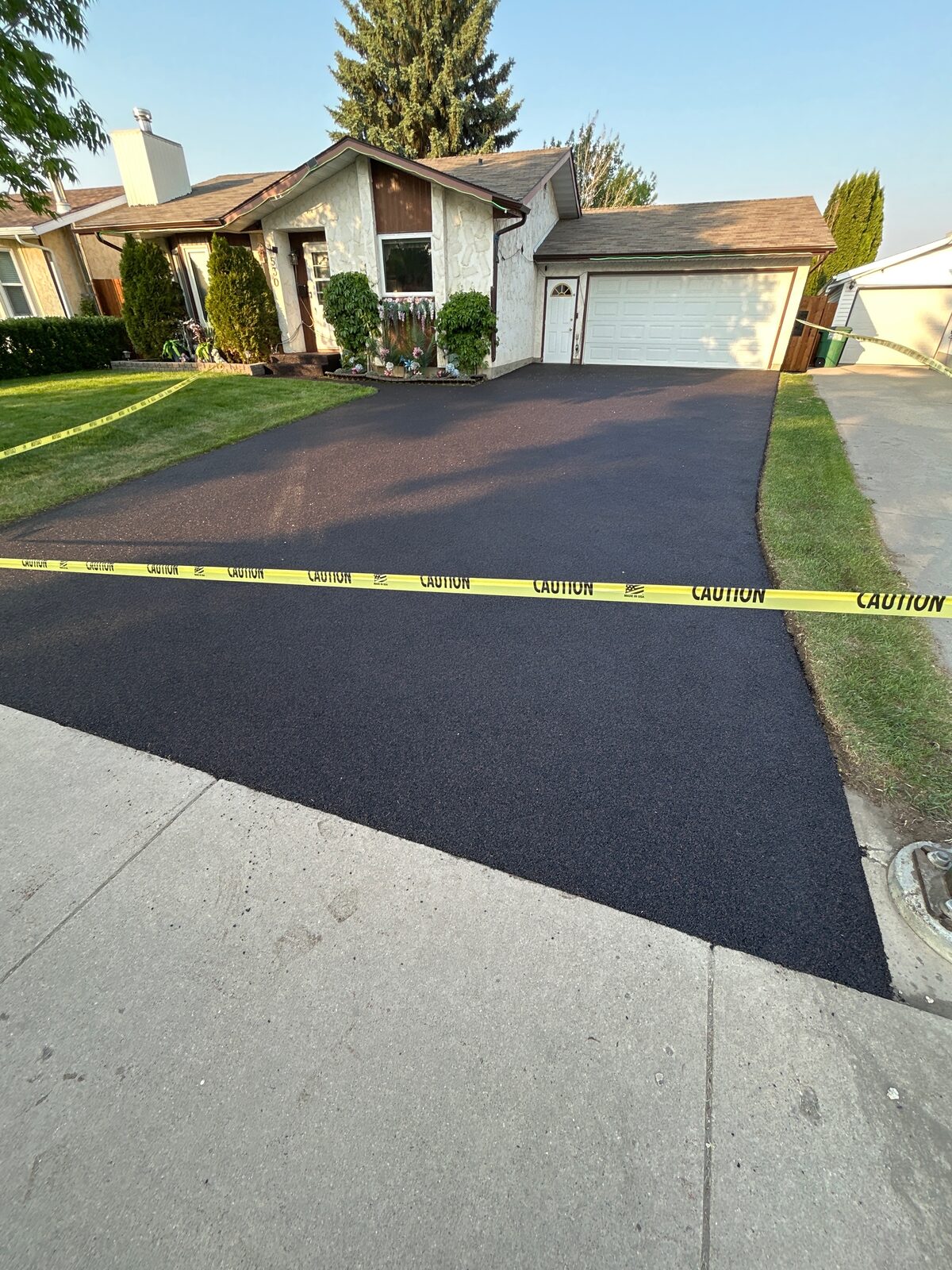 Freshly resurfaced black rubber driveway