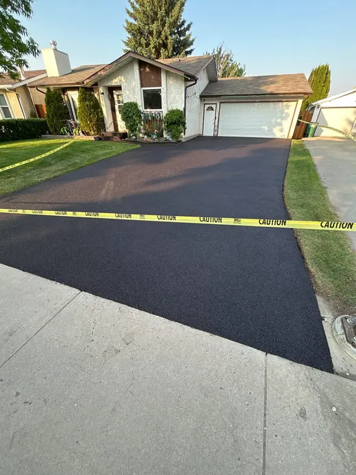 Freshly resurfaced black rubber driveway