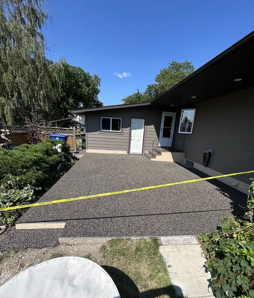 Backyard patio resurfaced in a grey fleck rubber blend