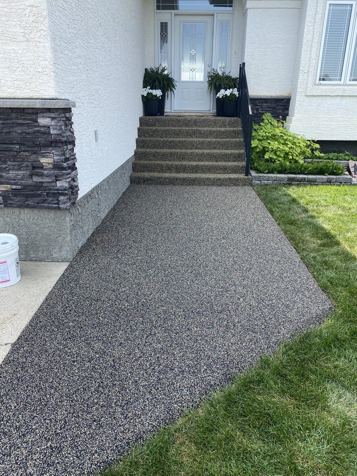 Black rubber steps leading to a front door