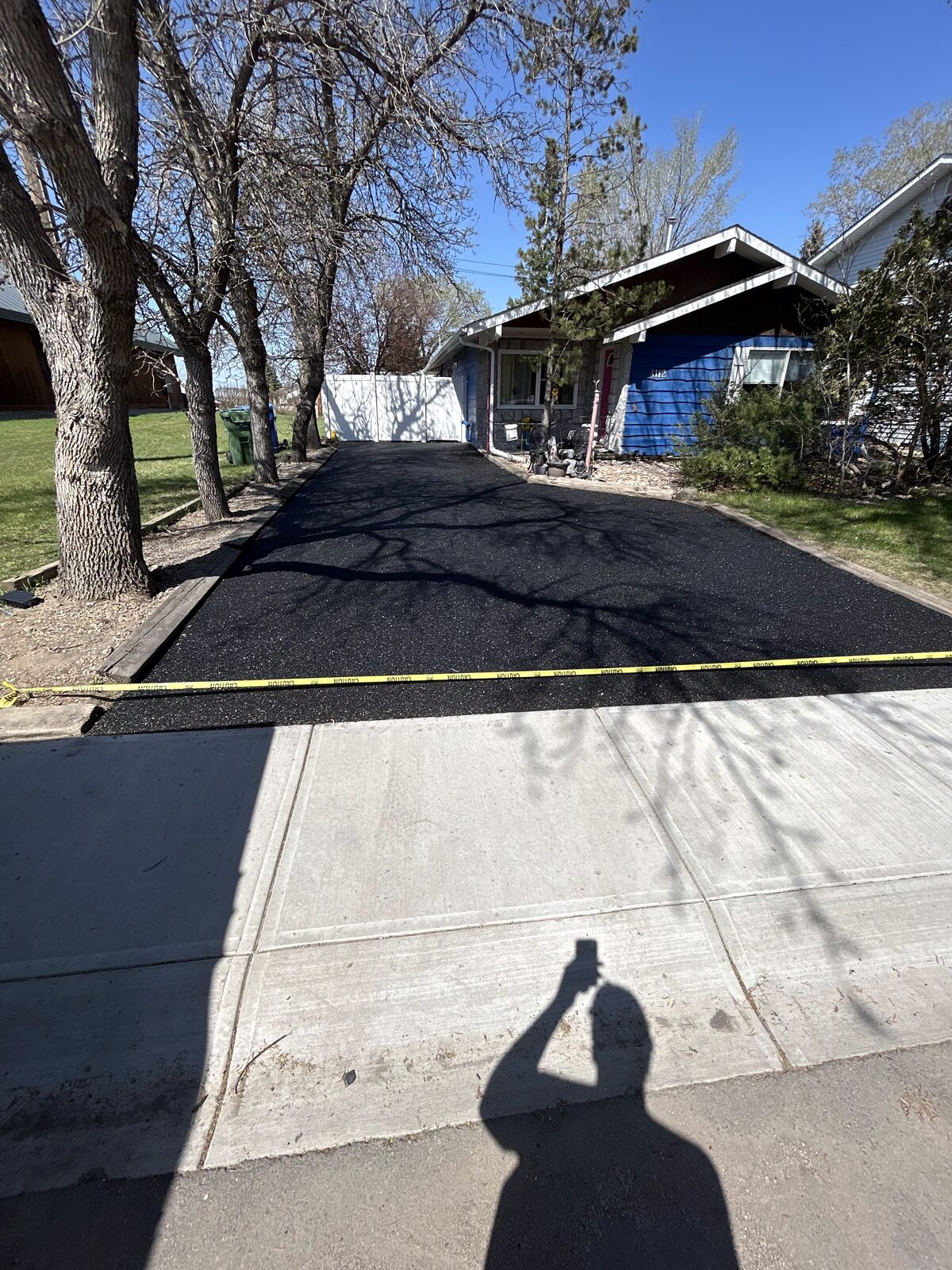Driveway after rubber resurfacing, smooth black finish